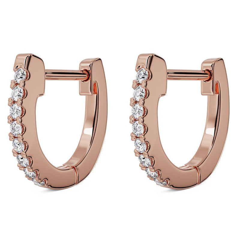 Pair of 14k rose gold diamond huggie hoop earrings, angled view showing hinged clasp and diamond row