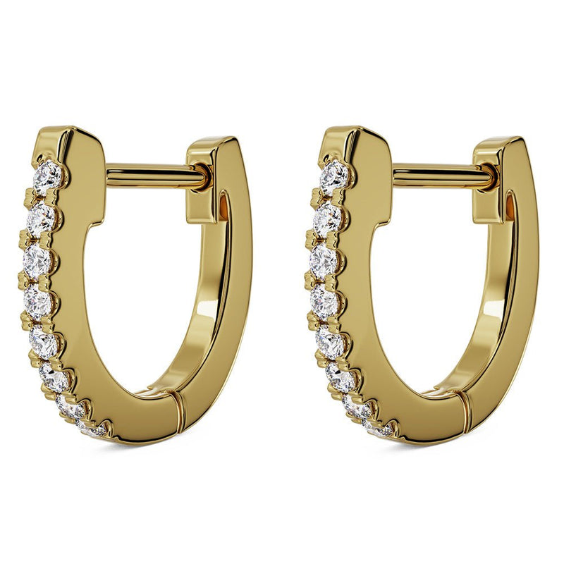 Pair of 14k yellow gold diamond huggie hoop earrings, angled view showing hinged clasp and sparkle detail