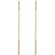 Close-up of 14k yellow gold diamond chain dangle earrings highlighting pavé bar and chain detail
