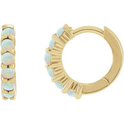 14k yellow gold opal huggie hoops with genuine 2mm opals set along the front arc