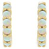 Close-up front view of 14k yellow gold huggie hoops showing paired opal stone detail and prong setting