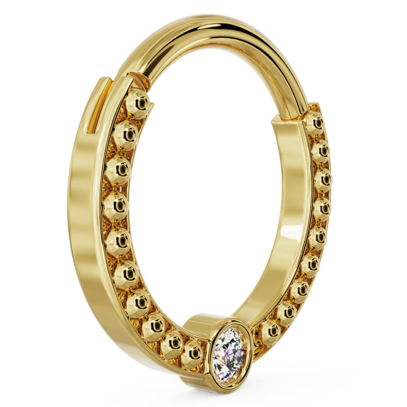 Angled view of larger 14k yellow gold dome bead clicker ring showing hinge mechanism and diamond