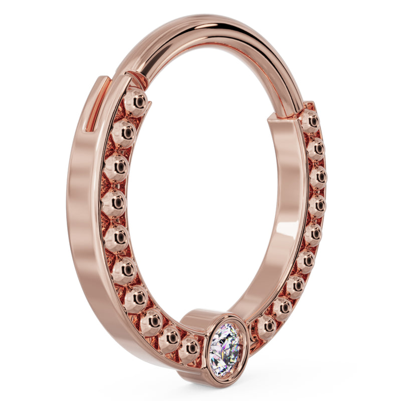 Angled view of larger 14k rose gold dome bead clicker ring showing double-row bead texture
