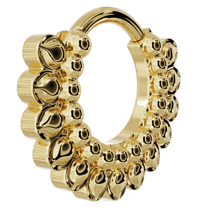 Side profile of 14k yellow gold petal clicker hoop showing depth of stacked petal texture