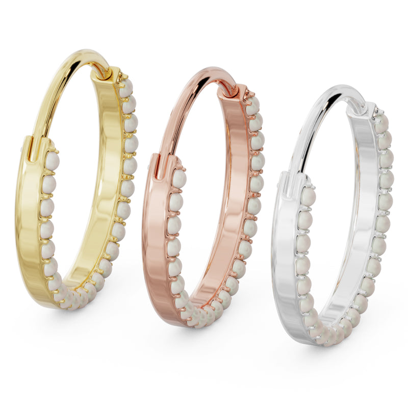Three large pearl clicker hoops in 14k yellow, rose, and white gold, angled side view comparison