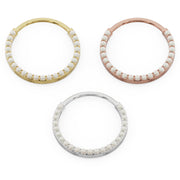 Large pearl clicker ring hoops in yellow, rose, and white gold shown from above in size comparison