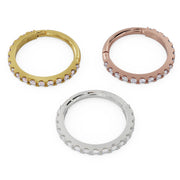 Diamond infinity clicker ring in 14k yellow, rose, and white gold displayed together, reverse-angle top view