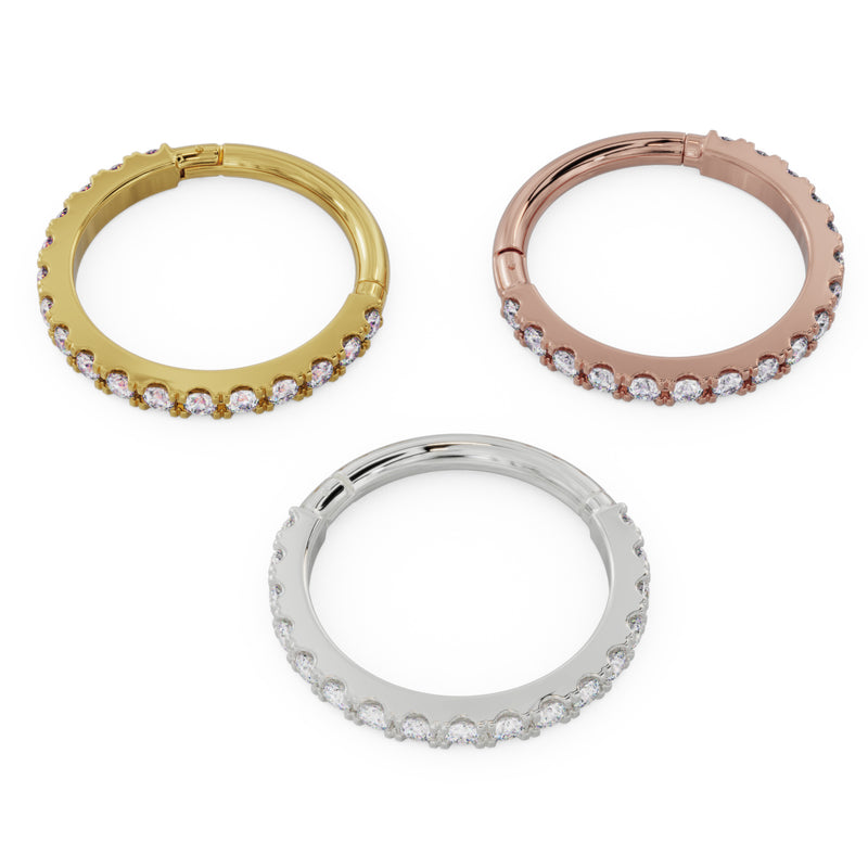 Diamond infinity clicker ring in 14k yellow, rose, and white gold displayed together, reverse-angle top view