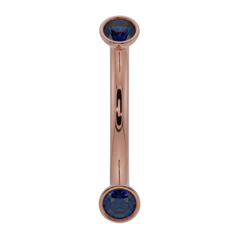 14k rose gold curved barbell with dual bezel-set blue sapphires, front view