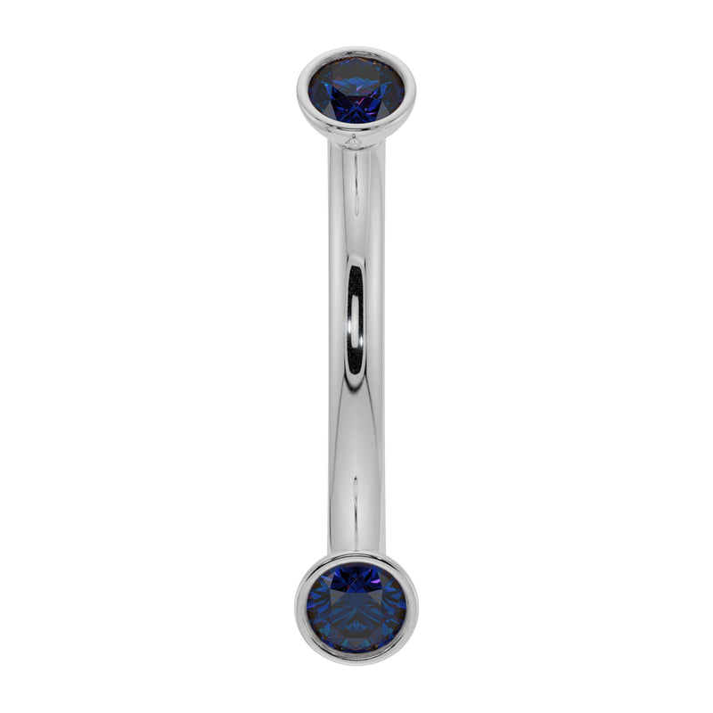 14k white gold curved barbell with dual bezel-set blue sapphires, front view