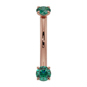 14K rose gold dainty emerald curved barbell with dual prong-set round emeralds, front view