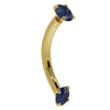14K yellow gold blue sapphire curved barbell, side profile showing gentle curve and prong-set ends