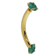 14K yellow gold emerald prong-set curved barbell, angled side view showing curved banana bar