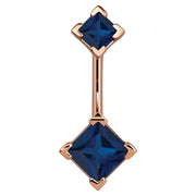 14k rose gold belly ring with double dark blue princess-cut CZ gems in four-prong settings, front view