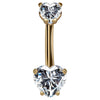 14k yellow gold belly ring with dual clear CZ heart stones in prong settings, front view