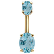 14k yellow gold navel ring with dual light blue oval CZ stones in four-prong settings, front view
