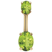 14k yellow gold navel ring with dual light green oval CZ stones in four-prong settings, front view