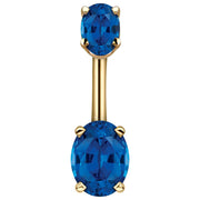 14k yellow gold belly ring with dual deep blue oval CZ stones in prong settings, front view