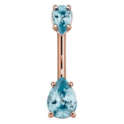 14k rose gold navel ring with dual light blue pear-cut CZ stones in prong settings, front view