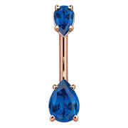 14k rose gold belly ring with two deep blue pear-shaped CZ gems in prong settings, front view