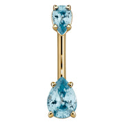 14k yellow gold belly ring with two light blue pear-cut CZ gems in basket prong settings