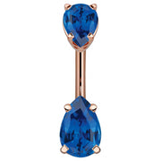 14k rose gold belly ring with double blue pear-cut CZ gems in four-prong basket settings, front view