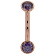 14k rose gold amethyst bezel curved barbell with larger round purple stones, angled view