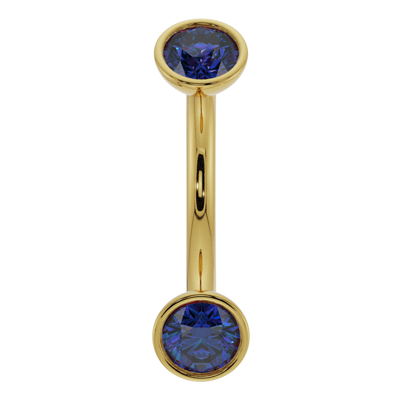 14k yellow gold blue sapphire bezel-set curved barbell, front view showing dual round gemstones