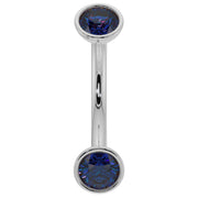 Close-up of 14k white gold curved barbell highlighting deep blue sapphire bezel ends