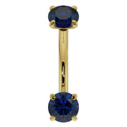14K yellow gold 14G blue sapphire curved barbell, front view with larger-gauge sapphire ends