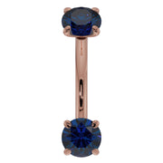 14k rose gold blue sapphire prong-set curved barbell, front view showing warm rose tone against deep blue gems