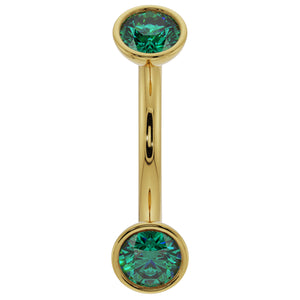 14k yellow gold curved barbell with dual bezel-set emeralds, front view on white background