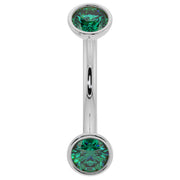 14k white gold 14G curved barbell with larger bezel-set round emeralds, front view