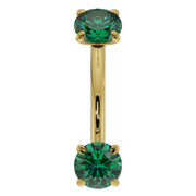 Close-up front view of 14K yellow gold emerald curved barbell highlighting larger 14G stone size