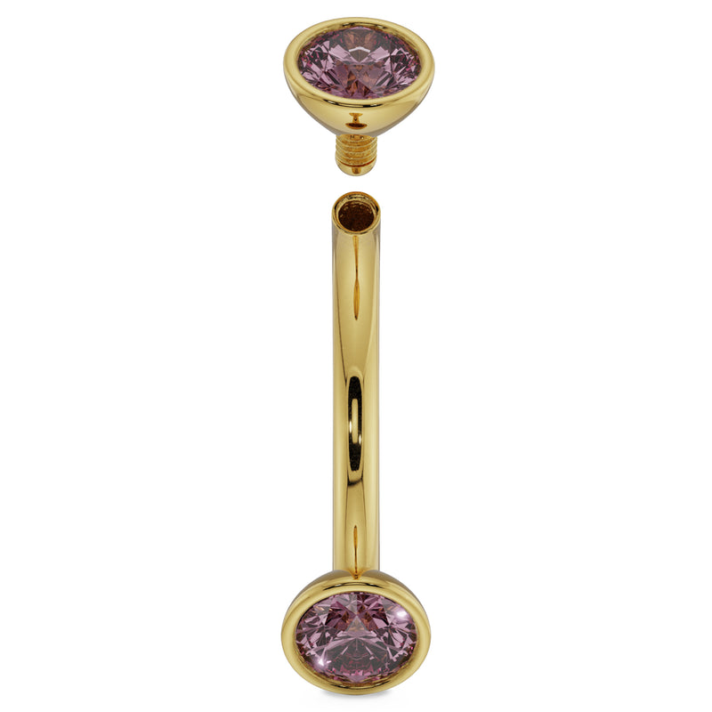 Angled view of 14K yellow gold pink sapphire curved barbell with top end cap detached