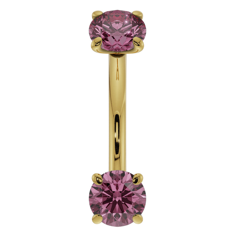 Close-up front view of 14k yellow gold pink sapphire curved barbell showing larger faceted stones