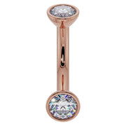 14K rose gold 14G CZ bezel curved barbell with larger 4mm CZ ends, belly ring gauge