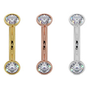 Diamond bezel-set curved barbell shown side by side in 14k yellow gold, rose gold, and white gold