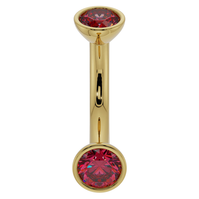 14k yellow gold 14G ruby curved barbell with larger bezel-set ruby ends, angled front view