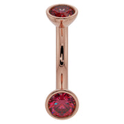 14k rose gold ruby bezel belly ring with larger ruby ends, warm pink-gold tone front view