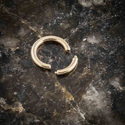 14K yellow gold segment ring open on dark marble surface, showing removable segment detail