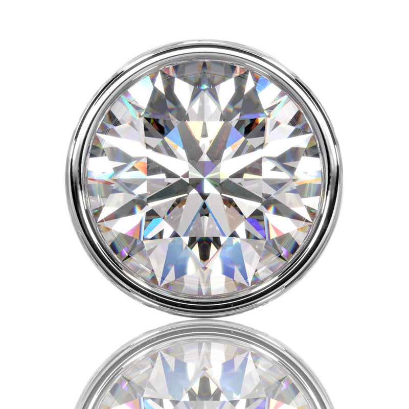 Extreme close-up of round brilliant diamond in bezel setting showing VS1 clarity and facet detail