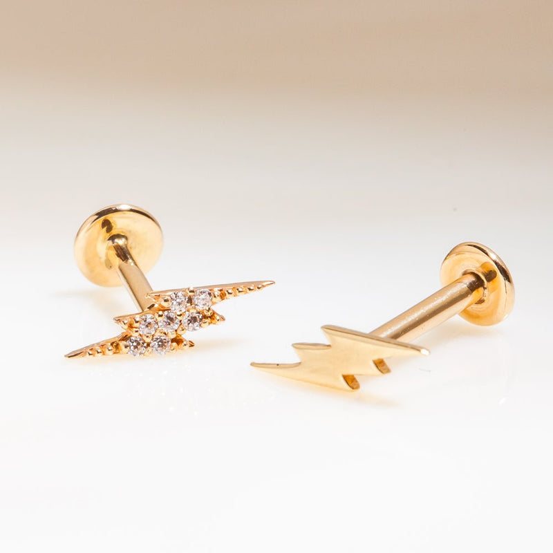 Yellow gold diamond pavé and plain lightning bolt flat back studs side by side for style comparison