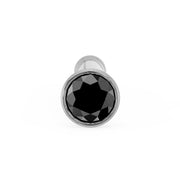 Front-on close-up of black diamond bezel nose bone stud in white gold, showing faceted stone