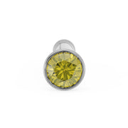 Front-on close-up of 1.5mm yellow diamond in white gold bezel nose stud, straight post visible