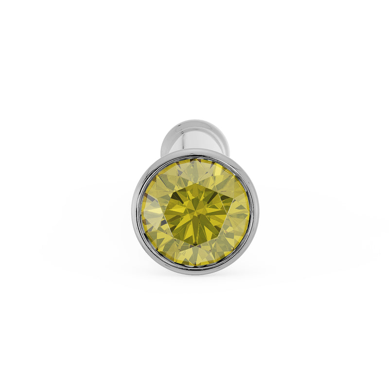 Front-on close-up of 1.5mm yellow diamond in white gold bezel nose stud, straight post visible