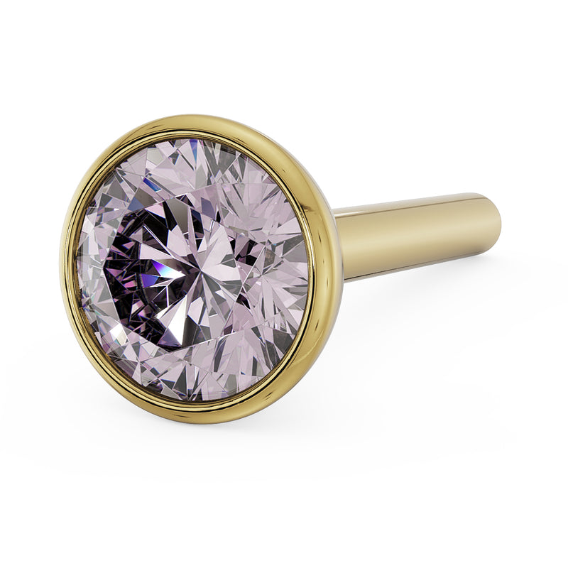 Angled close-up of 3mm pink diamond in 14k yellow gold bezel nose stud, straight post visible