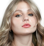 Model wearing 2.5mm diamond bezel flat back stud as a medusa lip piercing, front-facing portrait