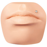 Square CZ 14K gold labret shown in Monroe piercing placement on silicone face model