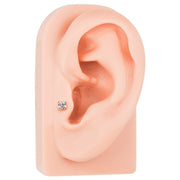 Square CZ 14K gold labret shown in tragus piercing on silicone ear model, side angle